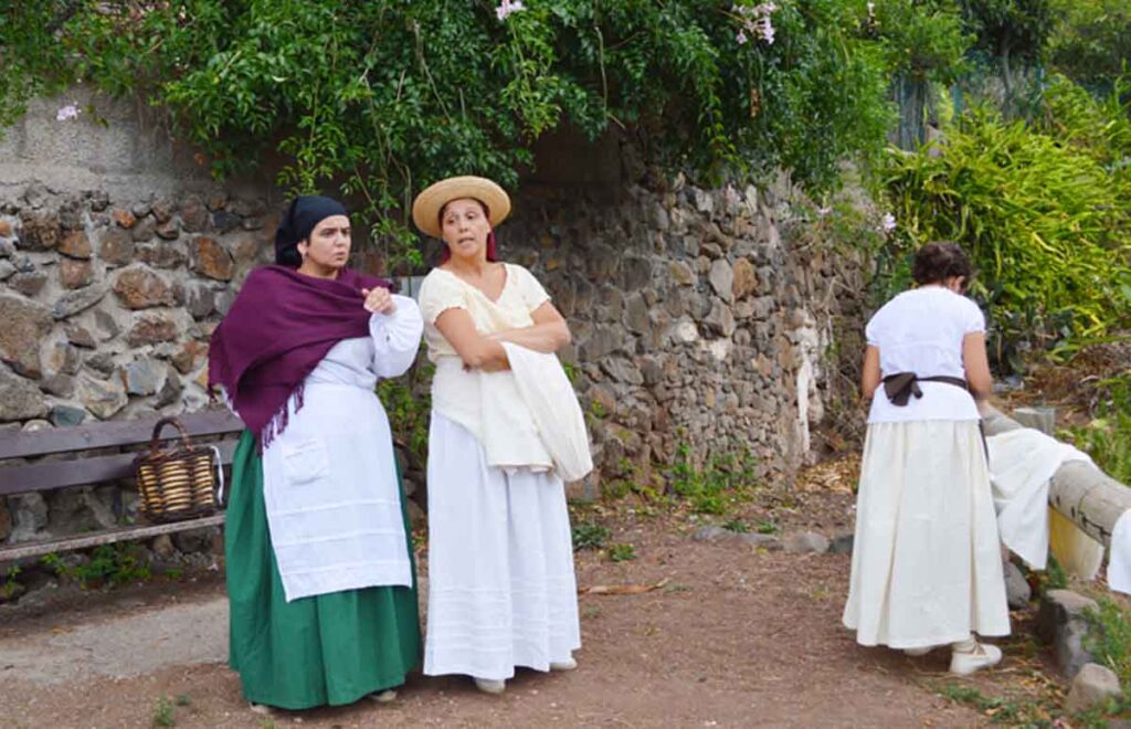 En la zona de las pilas, un grupo de mujeres charla mientras lava y arregla la ropa